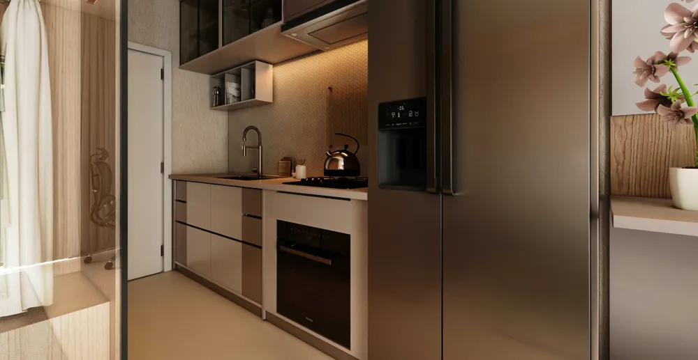 Cozinha do studio com armários em tons de bronze e geladeira duplex